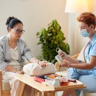 caregiver checking blood pressure