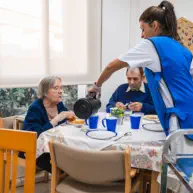 caregiver giving a meal