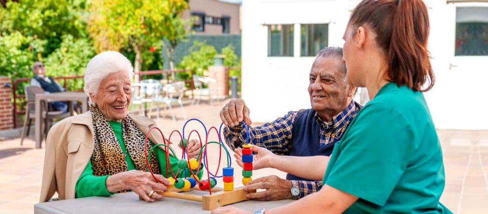 caregiver and elderly playing together