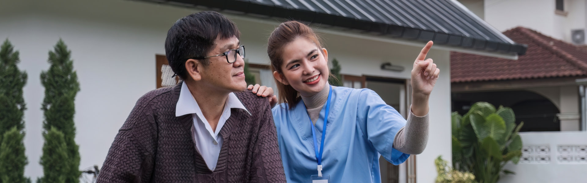caregiver and elderly person outside