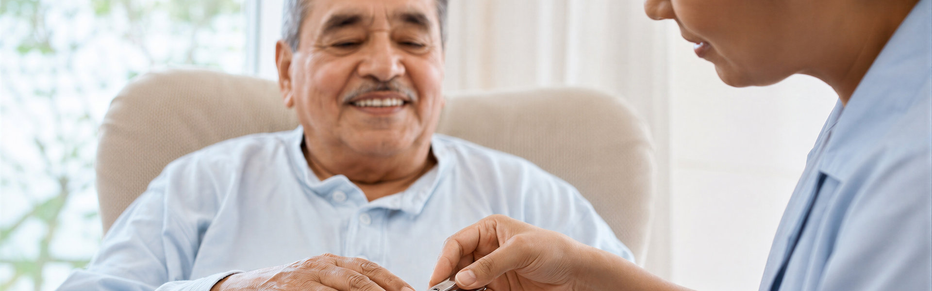 Woman caregiver cutting nails of smiling elderly man